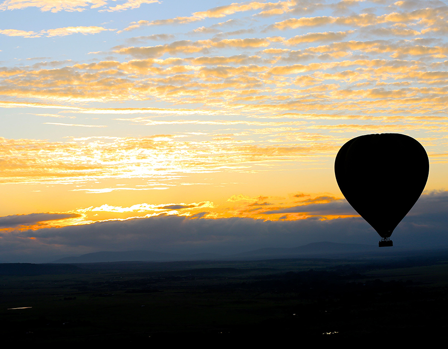 A hot-air balloon over the Mara at dawn